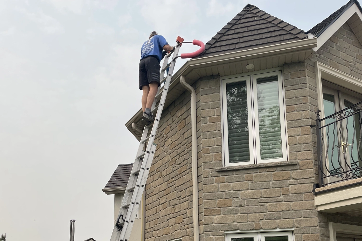 Porter Bros Employee on a ladder at a Grimsby gutter cleaning job