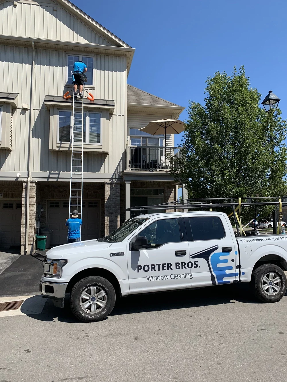 Porter Bros team installing Christmas Lights on a house in Niagara